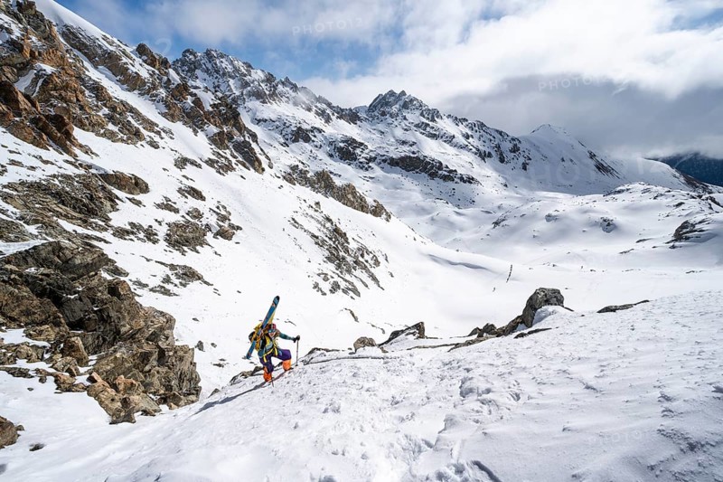 Mountaineer with skis climbing up a steep snow slope to the fork Porta d'Es-cha, ski tour Bündner Haute Route, Albula Alps, Rhaetian Alps, Grisons, Eastern Switzerland, Switzerland, Europe