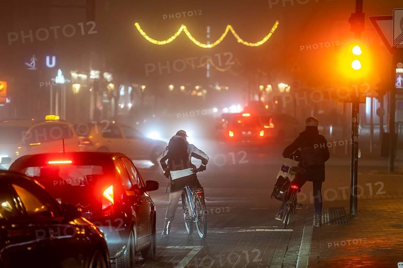 Cyclist, darkness, inner city traffic, Rüttenscheider Straße, bicycle lane, fog, autumn, winter, evening traffic, North Rhine-Westphalia, Germany, Europe