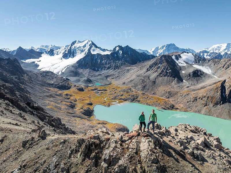 Hiker at the pass at 4000m, aerial view, mountains with glacier, mountain pass and mountain lake Ala-Kul Lake, Tien Shan, Kyrgyzstan, Asia