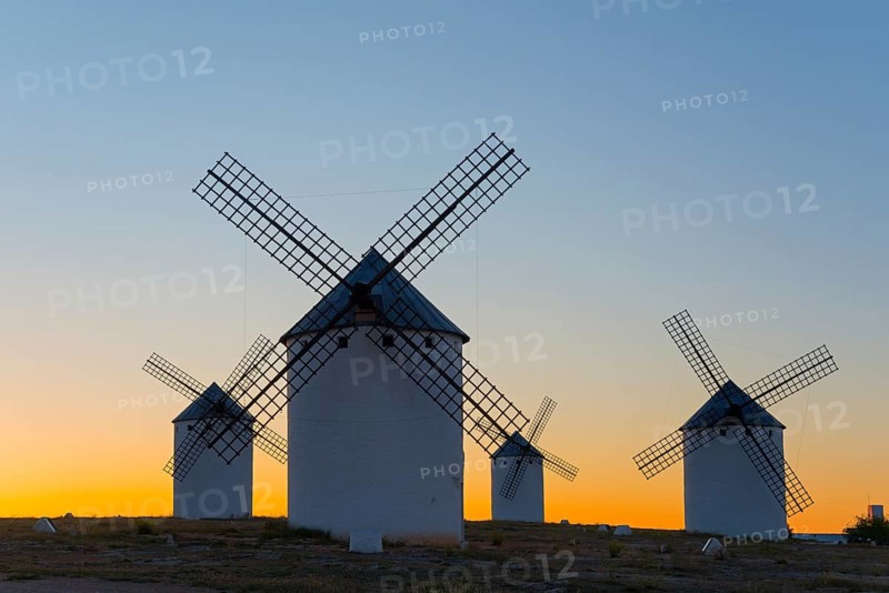 Windmills silhouetted against a soft evening sky, Campo de Criptana, Ciudad Real province, Castilla-La Mancha, Don Quixote Route, Spain, Europe