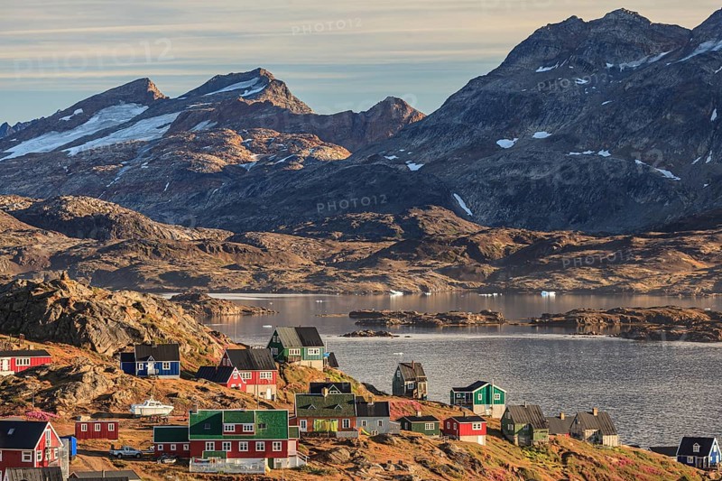 Typical Greenlandic houses on a fjord with steep mountains, Inuit settlement, autumn, Tasiilaq, East Greenland, Greenland, North America