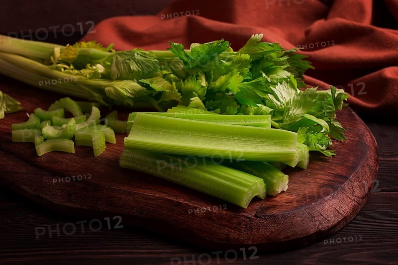 Fresh bunch of celery, top view, no people, on a dark background