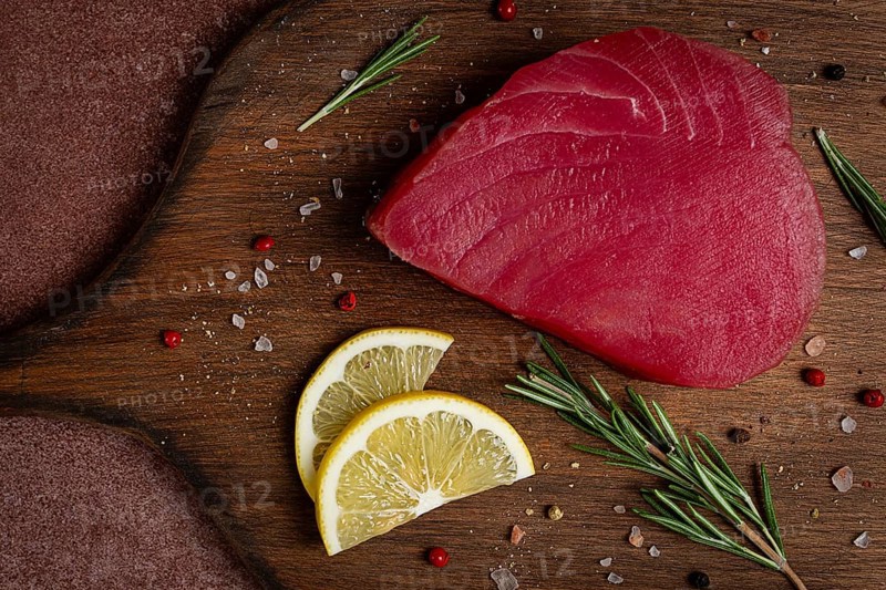 Fresh red tuna fillet, for steak, raw, top view, on a cutting board, no people