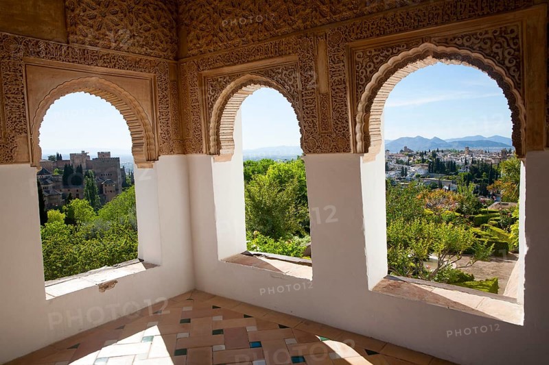 Arched decorated Moorish stone windows looking over gardens, Generalife garden, Alhambra, Granada, Spain, Europe