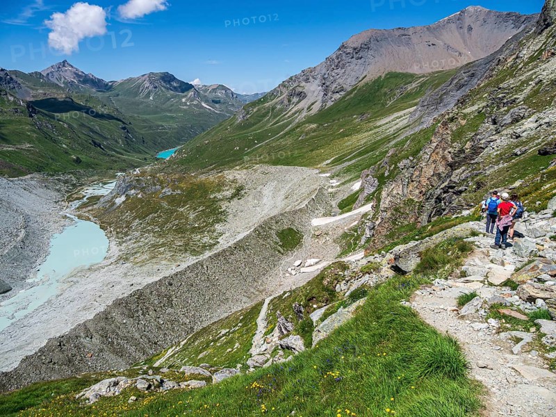 Hiking trail up to mountain hut Cabane de Moiry, glacial moraine, lake Lac de Moiry in the back, Valais, Switzerland, Europe
