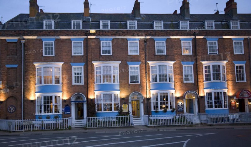Row of guest houses and small hotels at night on the Esplanade, Weymouth, Dorset, England, United Kingdom, Europe