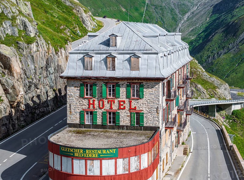 Hotel Belvédère on the Furka, the most famous pass hotel in the world. The building is closed and falling into disrepair. A lost place. Rhone glacier. Drone photo. Obergoms, Canton Valais, Switzerland, Europe