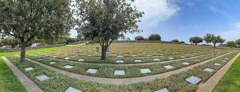 Panoramic photo wide view over part of German military cemetery inaugurated in 1974 by Volksbund Deutsche Kriegsgräberfürsorge on former battlefield in World War II heavily contested hill Height 107, Maleme, Crete, Greece, Europe