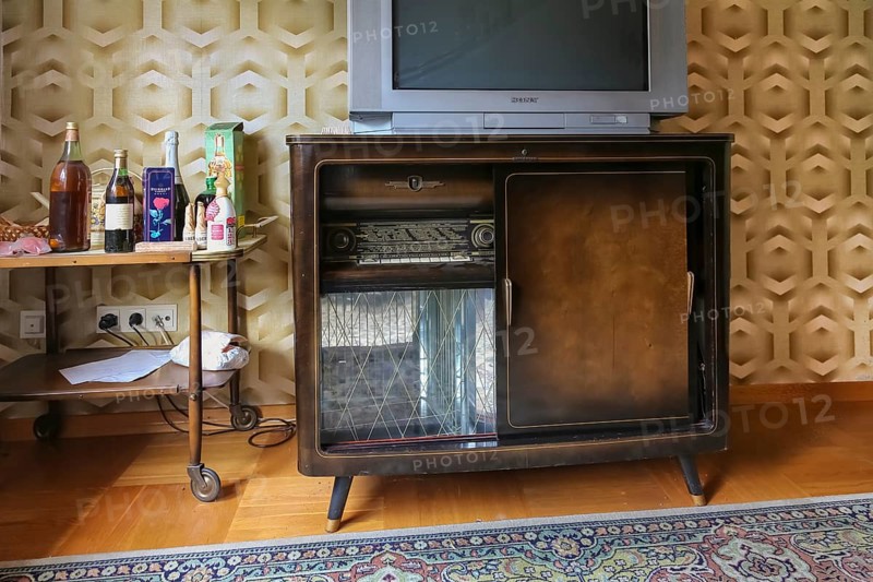 Lost Places, abandoned house, vacant building, old-fashioned furniture, good parlour, living room 1950s style, living in the economic miracle, furniture of the 50s, old radio, radio cabinet, liquor bottles, district Honau, Lichtenstein, Baden-Württemberg, Germany, Europe