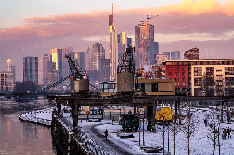 The skyline of Frankfurt am Main, skyscrapers of the banking district, historic harbour cranes at the Wesel shipyard, wintry morning, Hesse, Germany, Europe