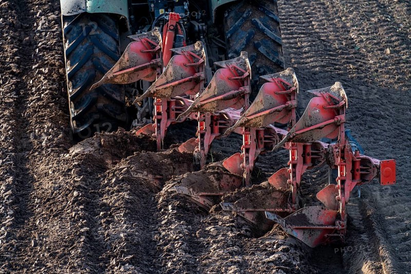 Farmer ploughing a field, tractor with plough, near Neuss, North Rhine-Westphalia, Germany, Europe