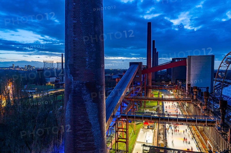 The ice rink at the Zollverein coking plant, Zollverein Coal Mine World Heritage Site, on the left the skyline of Essen city centre, North Rhine-Westphalia, Germany, Europe