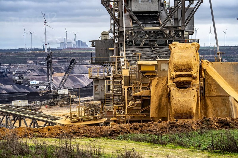 Opencast lignite mine Garzweiler 2, bucket wheel excavator 261 excavating the surface, at the rest of the hamlet of Lützerath, behind excavator 288, mining lignite, Neurath lignite-fired power station, wind farm, Erkelenz, North Rhine-Westphalia, Germany, Europe