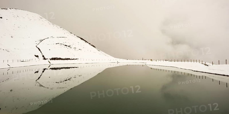 Onset of winter in May, Riezler Alpsee, an artificial lake, snow pond, feeds the snow cannons that provide the slopes of the Fellhorn and Kanzelwand cable cars with snow, Allgäu Alps, Vorarlberg, Austria, Europe