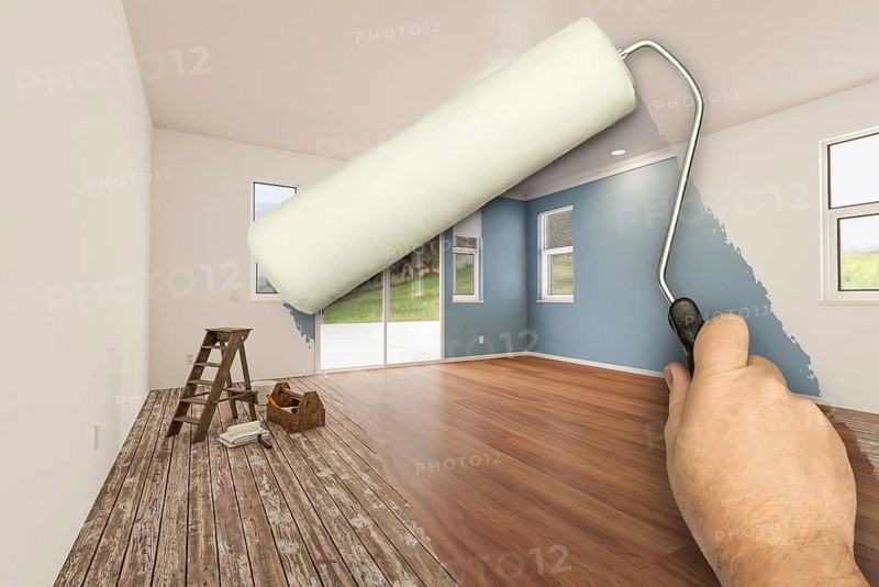Before and after of man using A paint roller to reveal newly remodeled room with fresh green paint, coffered ceiling and new floors