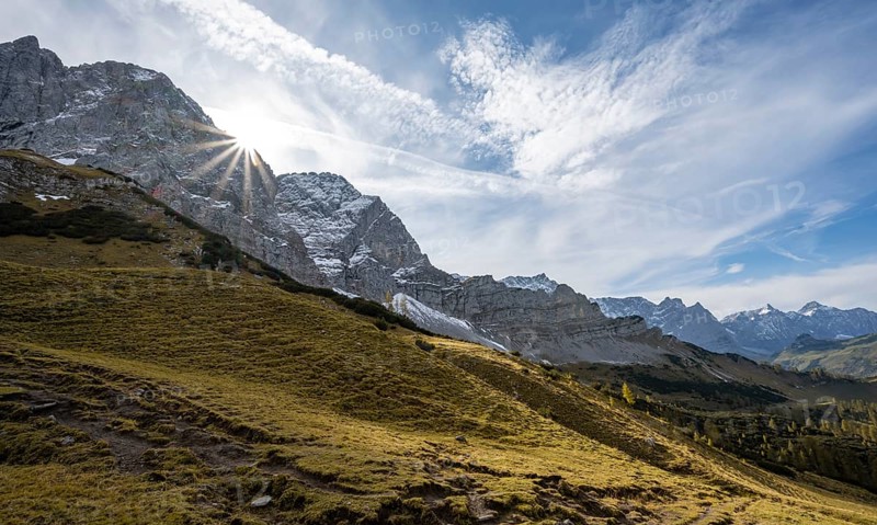 Mountain landscape with yellow meadows in autumn, summit Lamsenspitze with sun star, Karwendel, Tyrol, Austria, Europe
