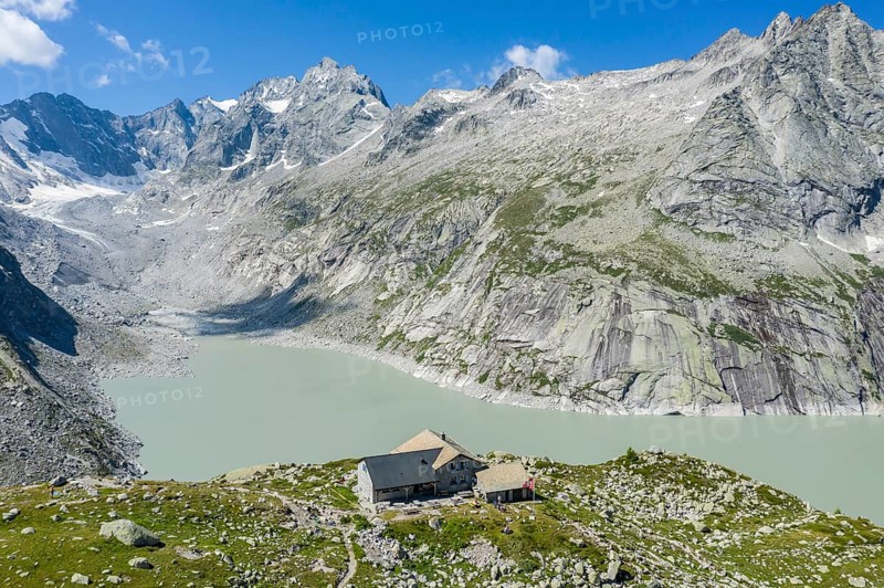 Capanna da l'Albigna, Albinga hut, above dam of reservoir Lake Albigna near village Vicosoprano, Bergell, Switzerland, Europe