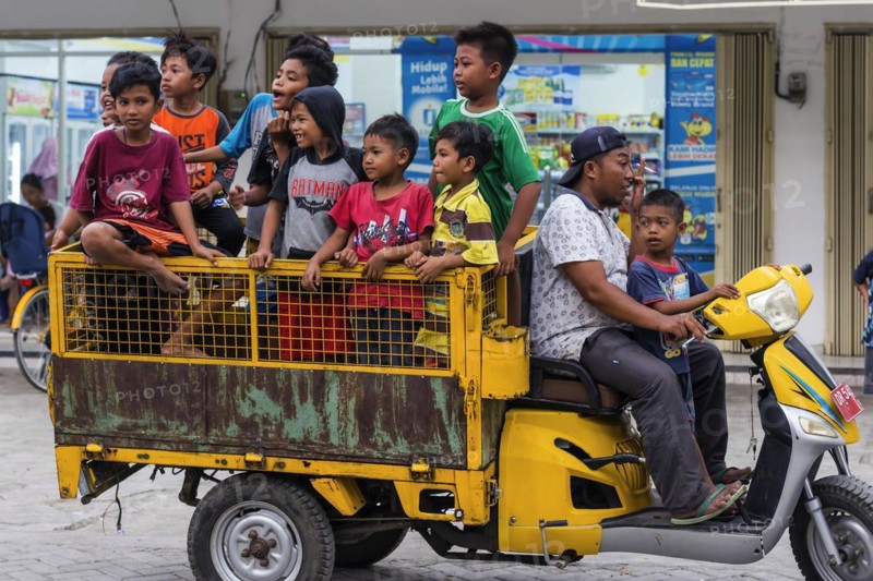Children on a vehicle in an Indonesian village, village, child, boy, curious, curiosity, childhood, carefree, lifestyle, village life, street scene, Asian, authentic, locals, tradition, traditional, travel, tourism, culture, poverty, person, Lombok, Indonesia, Asia