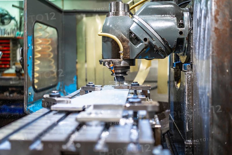 Milling machine molding shapes in metal pieces in a cnc factory with no people