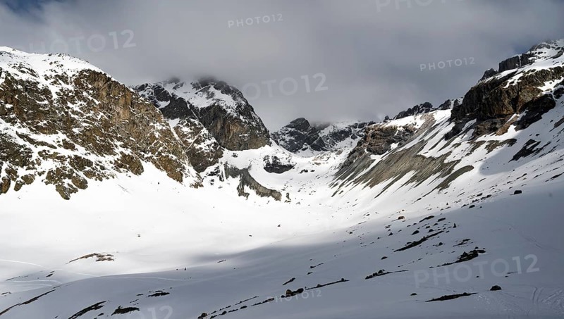High mountain valley with mountain peak Piz Calderas in winter, view at the Chamanna Jenatsch in winter, Grisons Haute Route, Albula Alps, Rhaetian Alps, Grisons, Eastern Switzerland, Switzerland, Europe