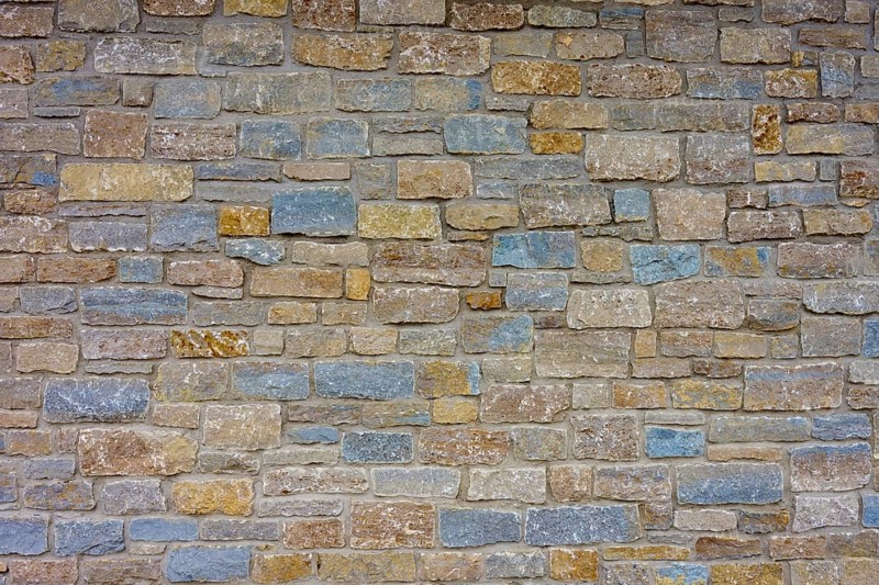 Wall of colourful natural stones in shades of blue and beige with uneven texture, Würzburg, Bavaria, Germany, Europe