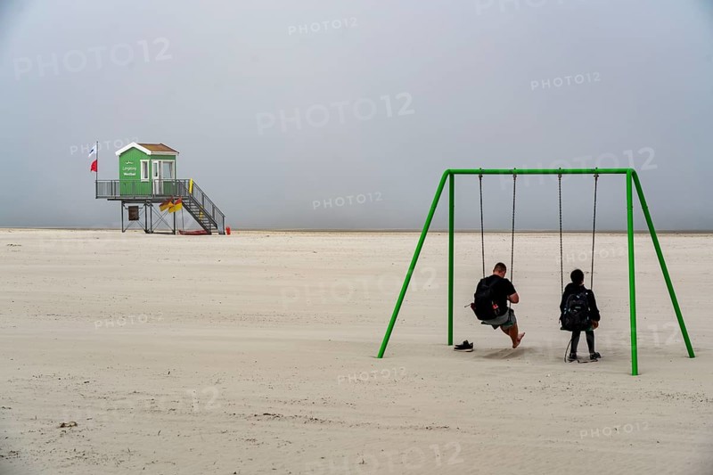 North Sea island of Langeoog, early summer, shortly after the first easing of the lockdown in the Corona crisis, foggy weather, still quite few tourists on the beach, DLRG watchtower, Lower Saxony, Germany, Europe
