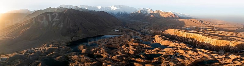 Panorama, White glaciated and snow-covered mountain peak Pik Lenin at sunrise, hilly landscape with golden meadows and lakes, aerial view, Trans Alay Mountains, Pamir Mountains, Osh Province, Kyrgyzstan, Asia