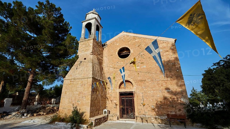 Church entrance with bell tower and Greek flags under a bright blue sky, Koroni, Byzantine fortress, nunnery, Peloponnese, Greece, Europe