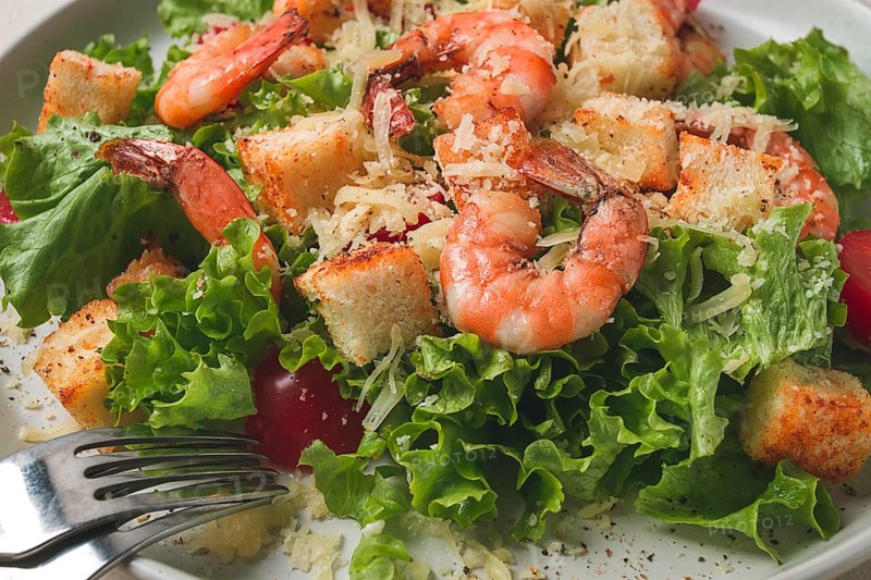 Caesar salad, with shrimp, on a white background, homemade, no people