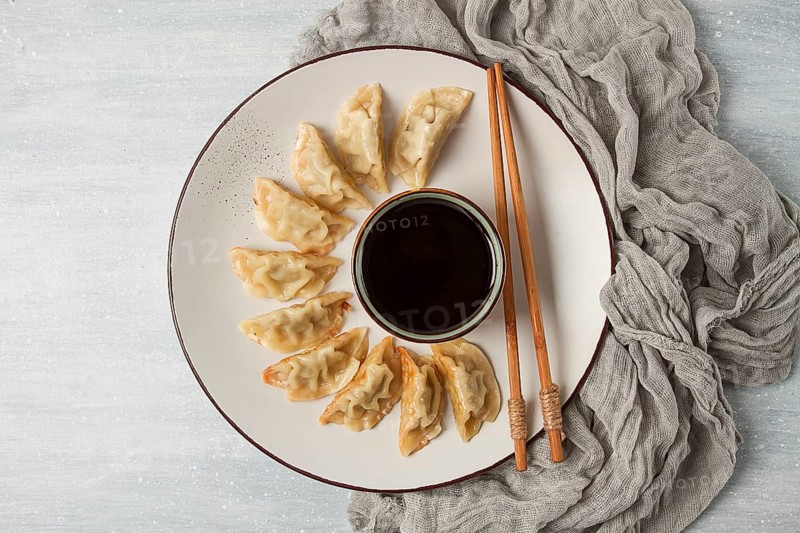 Japanese Gyoza dumplings, fried, with sauce, top view, without people, tinted, selective focus