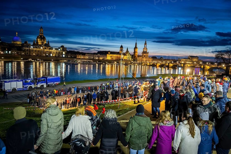 On 13 and 14 February 1945, Dresden was heavily destroyed in three Allied bombing raids. Every year, the people of Dresden commemorate this event at various events. A long human chain symbolised the protection of the city centre. Here looking from the Königsufer across the Elbe to the Old Town, Dresden, Saxony, Germany, Europe