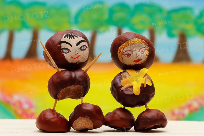 Two cute chestnut figures in front of a painted background, North Rhine-Westphalia, Germany, Europe