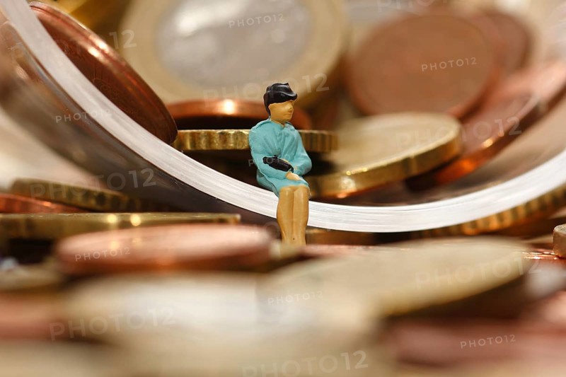 Miniature woman with euro coins, North Rhine-Westphalia, Germany, Europe