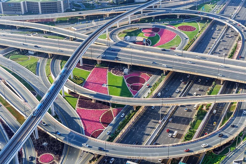 Intersection of Sheikh Zayed Road traffic on the road near the Burj Khalifa with Metro in Dubai, United Arab Emirates, Asia