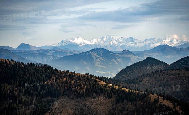 View of the Alpine foothills and main Alpine ridge with snow-covered peaks, summit of the Hohe Tauern with Großvenediger, from the Austrian Schinder, Bavarian Alps, Mangfall mountains, Bavaria, Germany, Europe