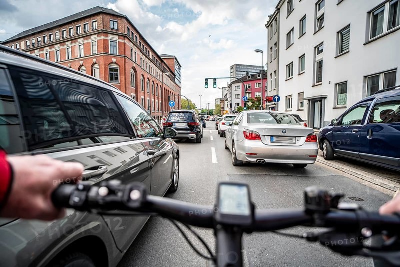 Cycling in the city, city centre road, no cycle lane, two-lane traffic in both directions, cyclists' perspective, Essen, North Rhine-Westphalia, Germany, Europe