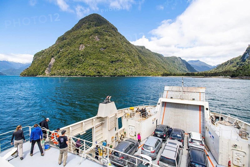 Passengers view the mountains and fjord landscape on the car ferry between Hornopirén and Caleta Gonzalo, Los Lagos region, Patagonia, Chile, South America
