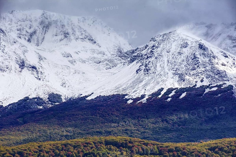 Snow-capped mountains of the Fuegian Andes with a hint of autumn landscape in Ushuaia against an impressive sky, Ushuaia, Argentina, South America