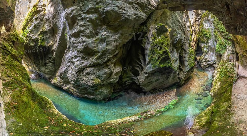 Scenic landscape showing tolmin gorges carving through rock formations with crystal clear turquoise water flowing through the canyon