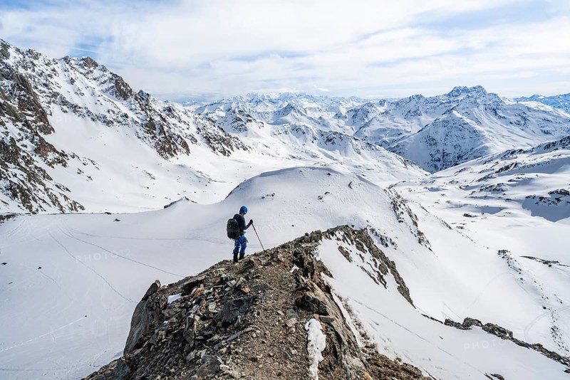 Mountain panorama with view of peaks of the Bernina group, mountaineer descending Piz Grialetsch in winter, Grisons Haute Route, Albula Alps, Rhaetian Alps, Grisons, Switzerland, Europe