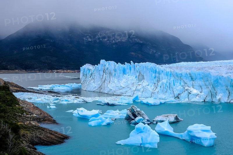 El Calafate, Patagonia, Argentina, Perito Moreno Glacier in Los Glaciares National Park. The Perito Moreno Glacier is part of the Patagonian ice field, the Campo Hielo Sur, the third largest freshwater reserve in the world. It is located in the province of Santa Cruz on Lago Argentino, the country's largest lake. The Perito Moreno Glacier is up to 30 kilometres long and 5 kilometres wide. Its edge is 70 metres high at its highest point. Small icebergs that have broken off from the glacier float in Lago Argentino. The glacier is one of the most beautiful sights in South America and is one of the most visited attractions in Argentina, South America