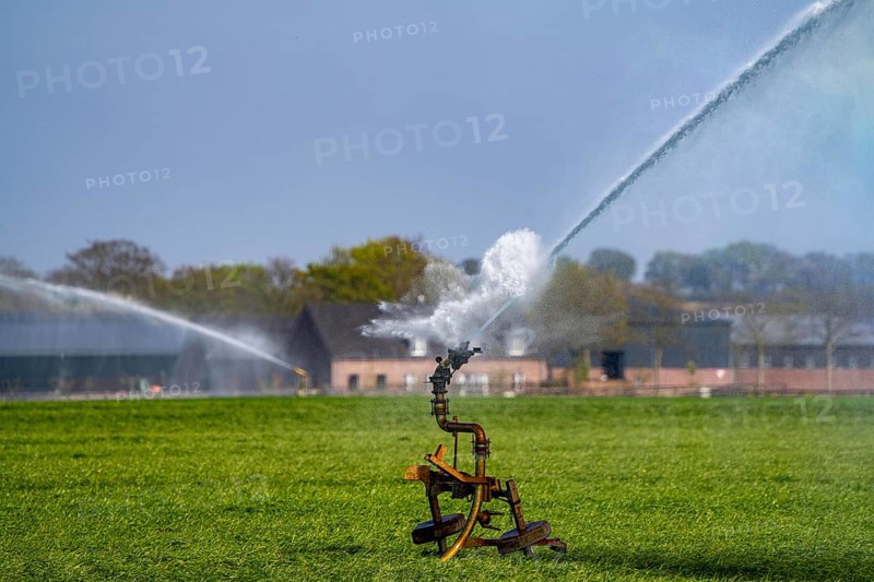 Artificial irrigation of a cereal field in April, with a sprinkler system, long dry spell in spring makes this necessary for the young plants to grow well, Kerken, Lower Rhine, North Rhine-Westphalia, Germany, Europe