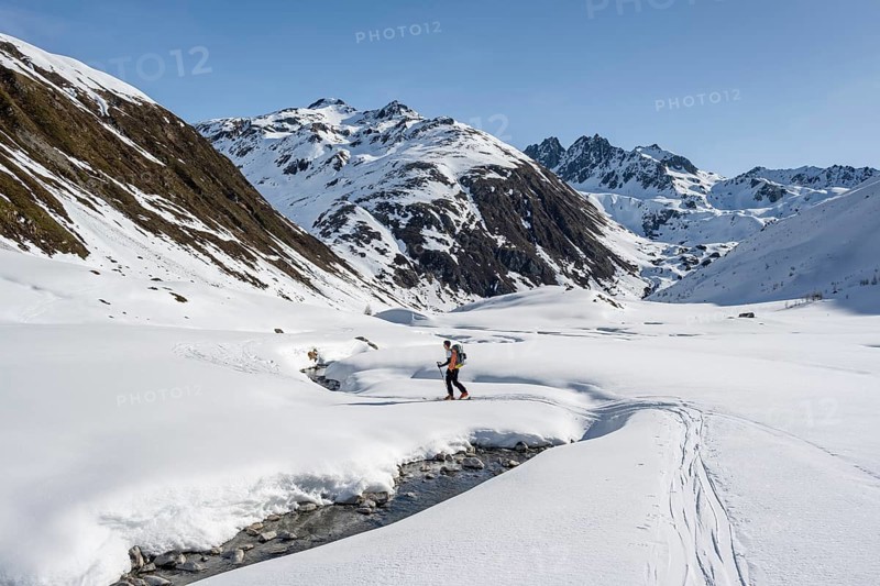 Ski tourers on the Graubünden Haute Route in the Val Susauna mountain valley, snow-covered mountains, winter in the Albula Alps, Graubünden, Switzerland, Europe
