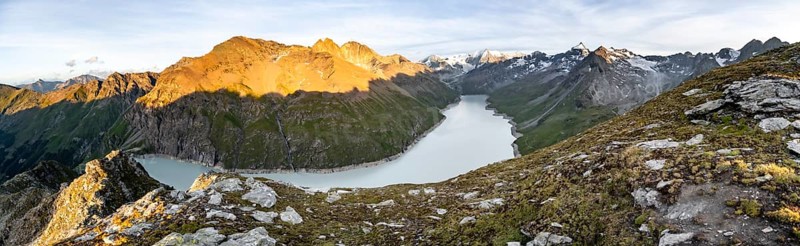 Picturesque mountain landscape at the summit Mont de la Blana at sunset, view of blue mountain lake, reservoir Lac des Dix and summit Mont Blanc de Cheilon with glacier, Hérémence, Valais, Western Alps, Switzerland, Europe