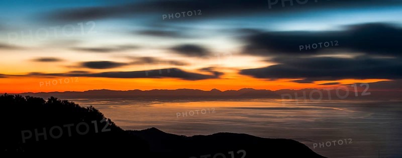 Atmospheric view with colourful evening sky shortly after sunset from Tuscan island Giglio to the west over Thyrrenian Sea Mediterranean Sea on island Corsica, Giglio, Tuscany, Italy, Europe