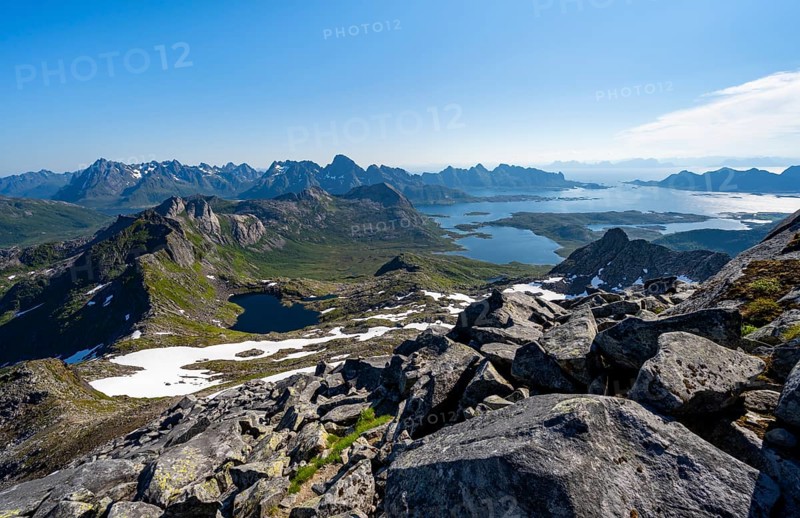 View of mountains and fjord landscape, mountain panorama, mountaineer at the summit of Rundfjellet, lake Hellskarvatnet and fjord Austnesfjorden, Svolvaer, Nordland, Norway, Europe