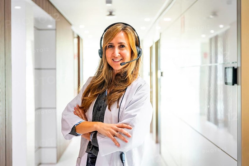 Portrait of a proud female hospital receptionist wearing headset to work