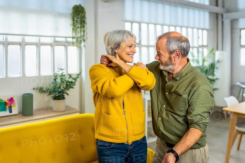 Senior happy modern couple dancing tango together at home