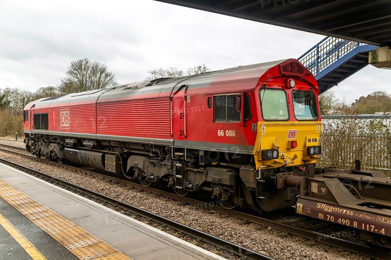 DB Cargo Class 66 freight train passing through Peterborough railway station, Cambridgeshire, England, UK