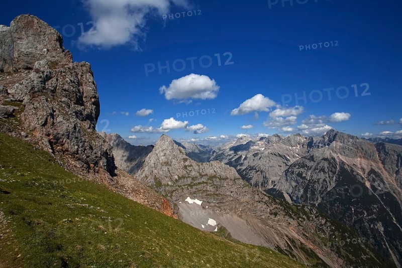 Fascinating view of high mountain peaks and clouds under a blue sky, Karwendel, Mittenwald, Bavaria, Germany, Europe
